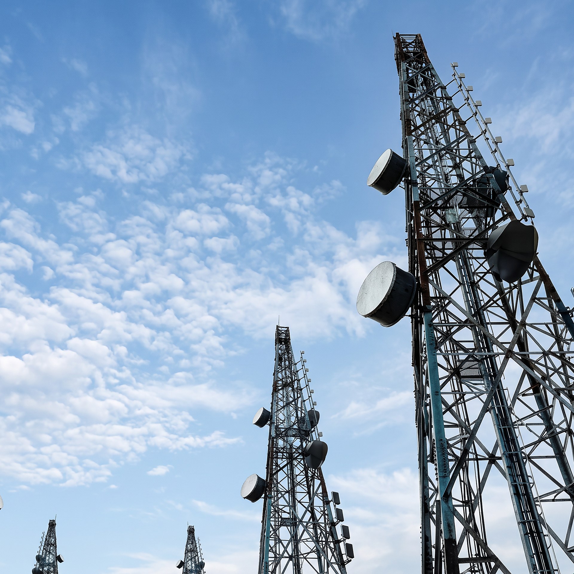 Steel telecom towers with antennas built on developed tower sites